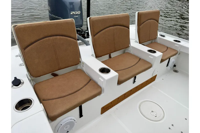 Slide: The Image of 2022 Sea Hunt BX 22 BR boat with tan cushioned seats and Yamaha 200 engine. - 19