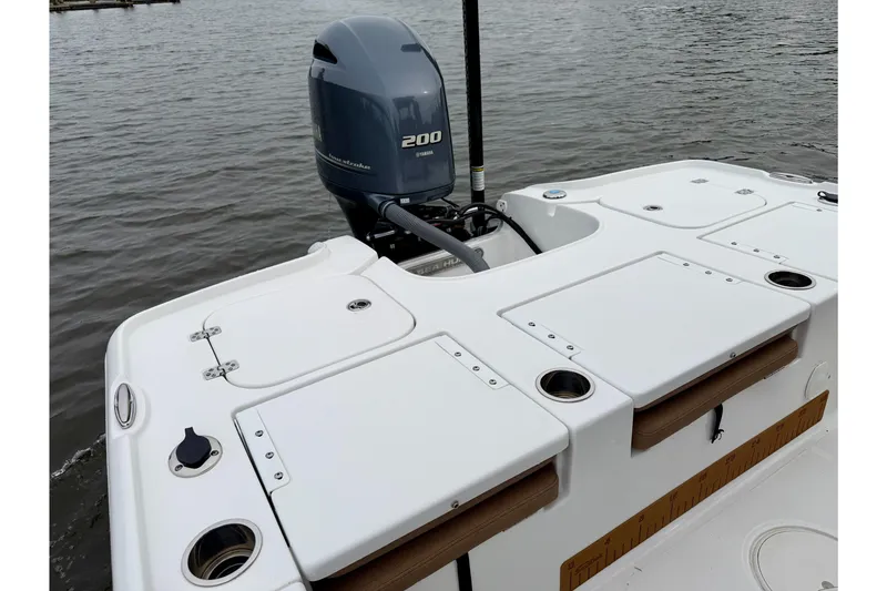 Slide: The Image of 2022 Sea Hunt BX 22 BR boat with Yamaha 200 engine on calm water. - 23