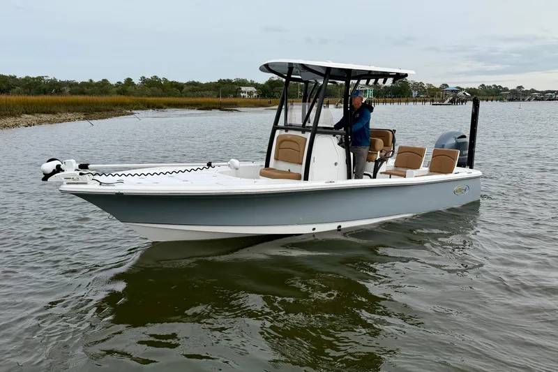 Slide: The Image of 2022 Sea Hunt BX 22 BR boat on calm water, featuring sleek design and modern amenities. - 3