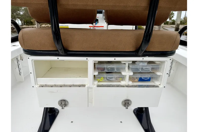 Slide: The Image of 2022 Sea Hunt BX 22 BR boat storage compartments with tackle boxes and seating. - 31