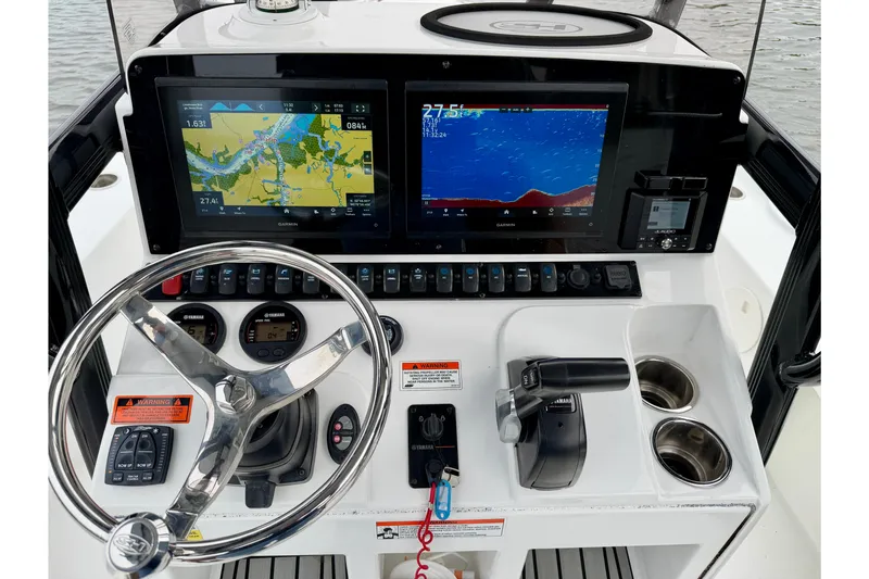 Slide: The Image of 2022 Sea Hunt BX 22 BR boat dashboard with navigation screens and controls. - 33