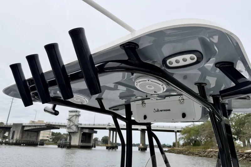 Slide: The Image of 2022 Sea Hunt BX 22 BR boat with rod holders and bridge in background. - 40