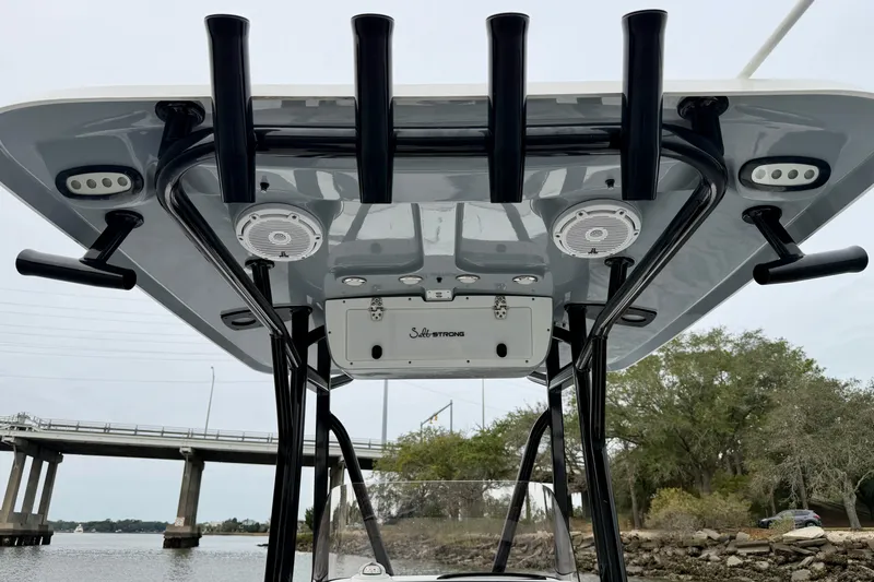 Slide: The Image of 2022 Sea Hunt BX 22 BR boat with T-top and rod holders, near a bridge. - 42