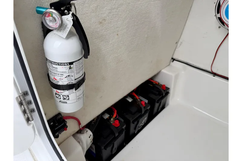 Slide: The Image of 2022 Sea Hunt BX 22 BR boat interior with fire extinguisher and battery compartment. - 45