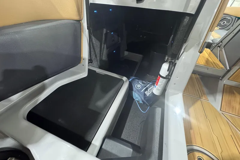 Slide: The Image of 2026 Supra SA interior storage area with fire extinguisher and Supra branded bag. - 19