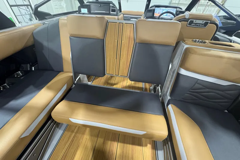 Slide: The Image of 2026 Supra SA boat interior with tan and black seating, wood accents, and modern dashboard. - 23