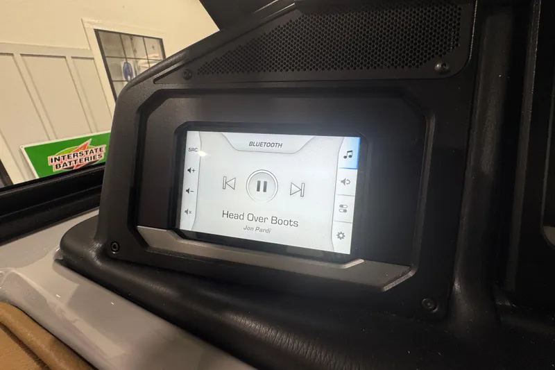 Slide: The Image of 2026 Supra SA boat dashboard with Bluetooth audio display playing "Head Over Boots." - 27
