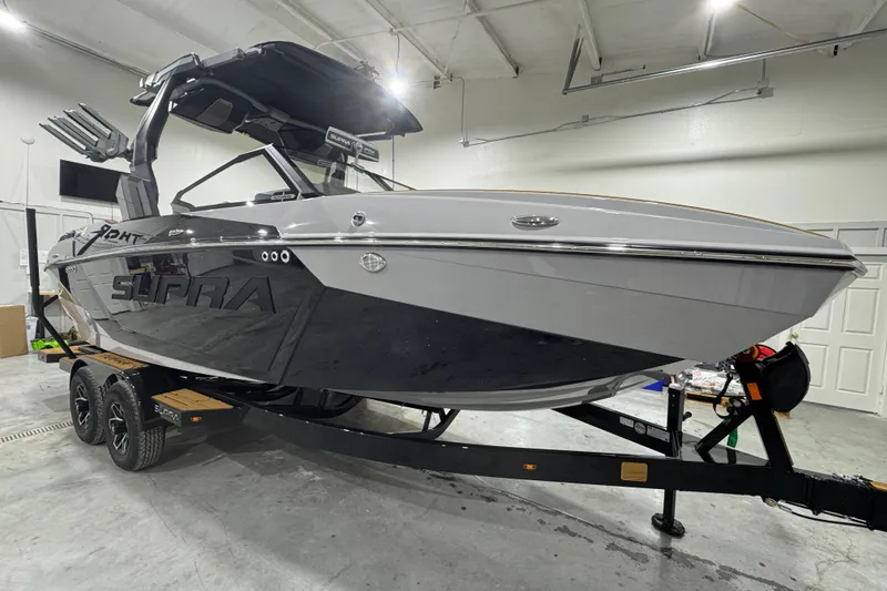 Slide: The Image of 2026 Supra SA boat on trailer in a garage, showcasing sleek design and modern features. - 9