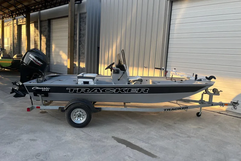 Slide: The Image of 2026 Tracker Bass Tracker Classic CC boat on trailer in a garage setting. - 49
