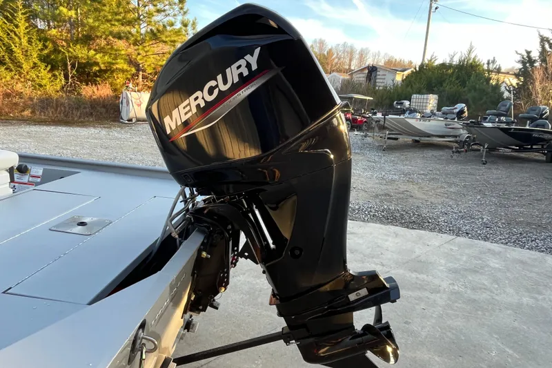 Slide: The Image of 2026 Tracker Bass Tracker Classic CC with Mercury outboard motor in a boatyard setting. - 54