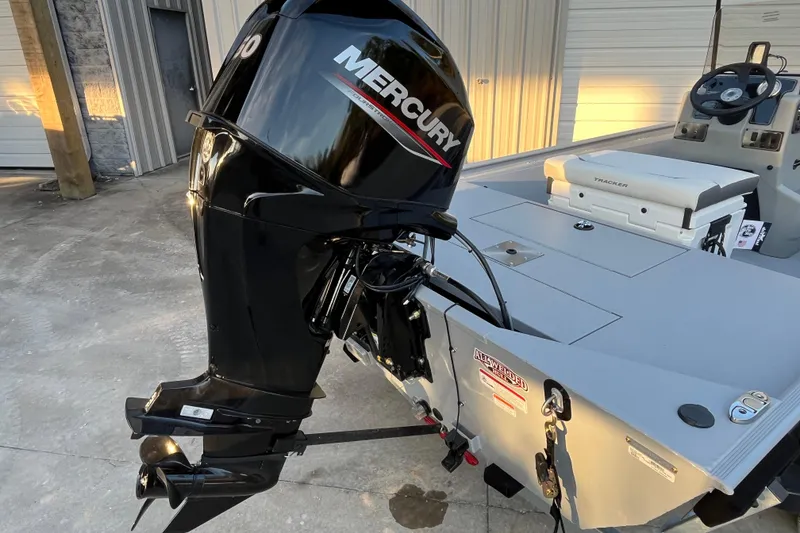 Slide: The Image of 2026 Tracker Bass Tracker Classic CC with Mercury outboard motor in a garage setting. - 56