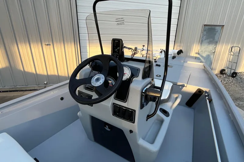 Slide: The Image of 2026 Tracker Bass Tracker Classic CC boat console with steering wheel and controls. - 62