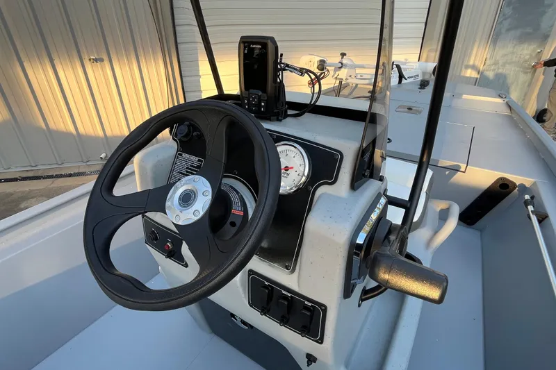 Slide: The Image of 2026 Tracker Bass Tracker Classic CC boat console with steering wheel and controls. - 64