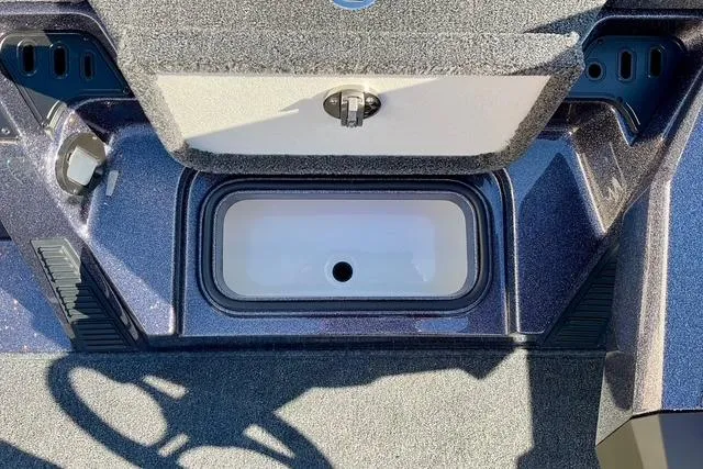 Slide: The Image of 2026 Ranger Z518 boat storage compartment with open lid, showcasing interior design. - 13