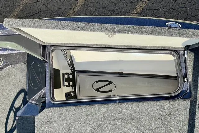 Slide: The Image of 2026 Ranger Z518 boat storage compartment with open lid, showcasing interior details. - 15