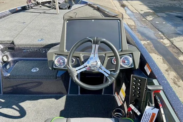 Slide: The Image of 2026 Ranger Z518 boat dashboard with steering wheel and control panel. - 21