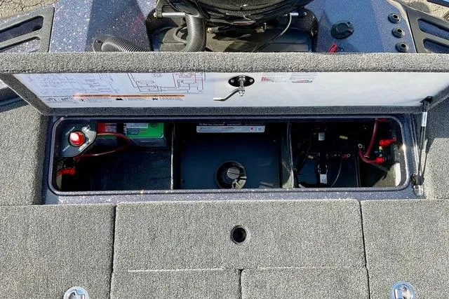 Slide: The Image of 2026 Ranger Z518 boat storage compartment with battery and wiring. - 26