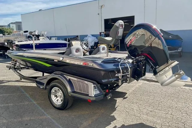 Slide: The Image of 2026 Ranger Z518 boat with trailer, parked outdoors, featuring sleek design and powerful engine. - 8