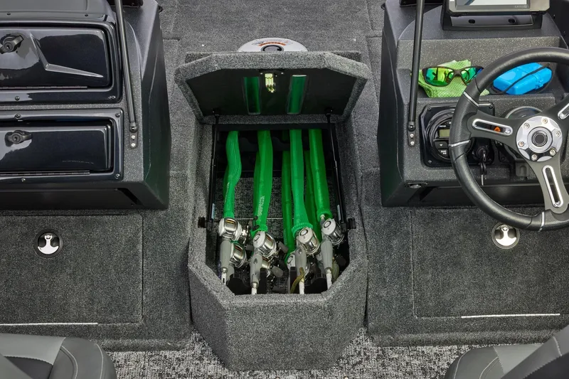 Slide: The Image of 2026 Tracker Targa V-19 Combo boat storage compartment with equipment and carpeted interior. - 20