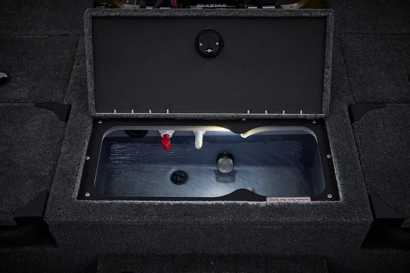 Slide: The Image of 2026 Tracker Targa V-19 Combo boat interior storage compartment with secure latch. - 42