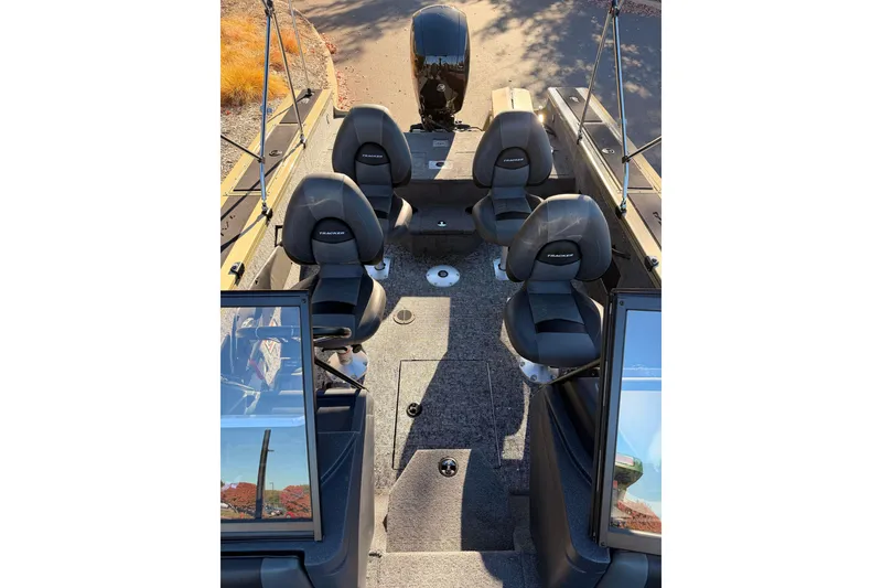 Slide: The Image of 2026 Tracker Targa V-19 Combo boat interior with four seats and motor. - 5