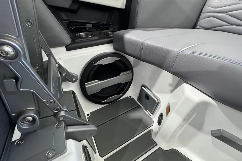 Slide: The Image of 2026 Supra SE interior with speaker, cup holders, and gray seating. - 17
