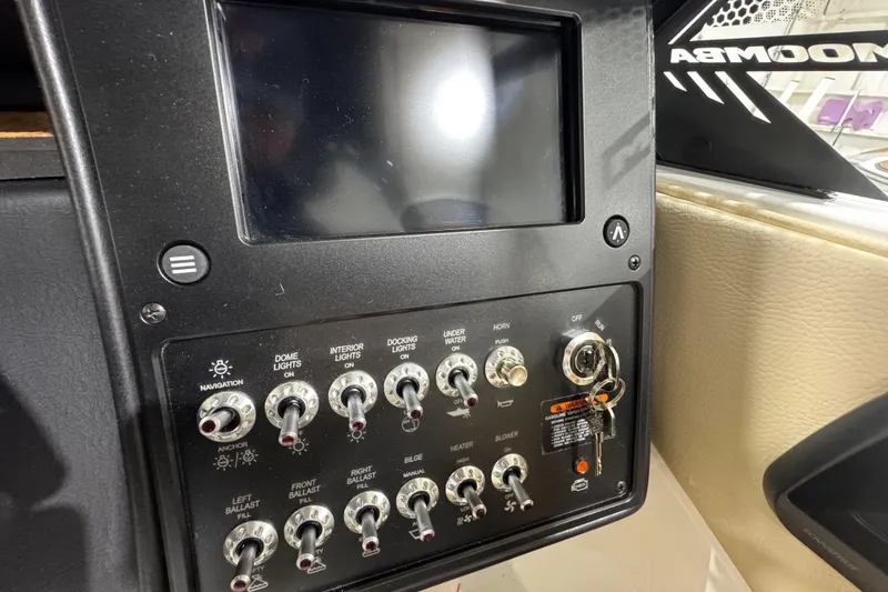 Slide: The Image of Control panel of 2026 Moomba Mojo boat with switches and ignition keys. - 17