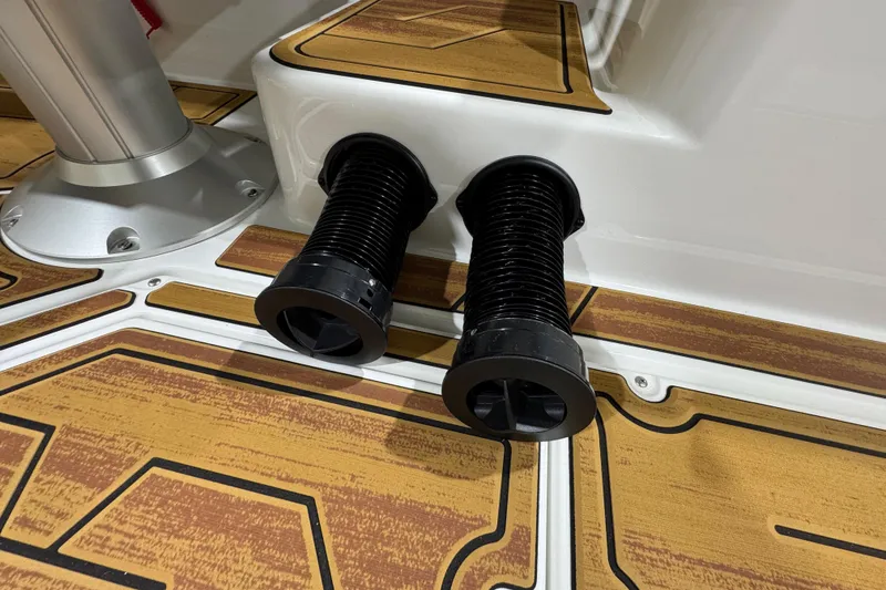 Slide: The Image of 2026 Moomba Mojo boat interior with dual black exhaust vents on wooden deck. - 21