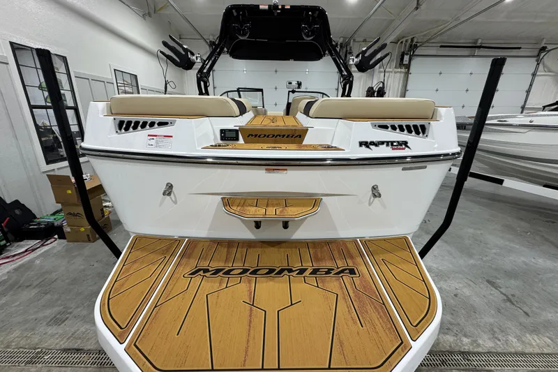 Slide: The Image of 2026 Moomba Mojo boat with Raptor engine, featuring teak-style deck in a showroom. - 3