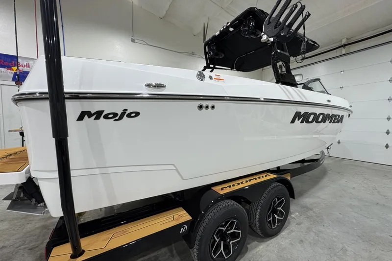 Slide: The Image of 2026 Moomba Mojo boat on trailer in indoor garage setting. - 5