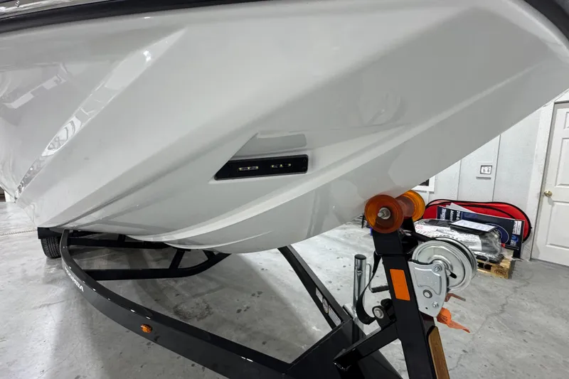 Slide: The Image of 2026 Moomba Mojo boat on trailer in a garage setting. - 7
