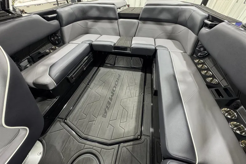 Slide: The Image of 2026 Moomba Max boat interior with gray seating and cup holders. - 11