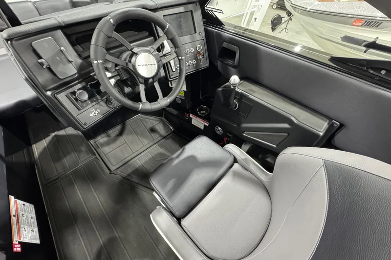 Slide: The Image of Interior of 2026 Moomba Max boat, featuring steering wheel and control panel. - 12