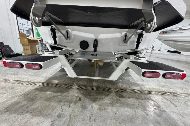 Slide: The Image of 2026 Moomba Max boat trailer with dual taillights in a garage setting. - 4