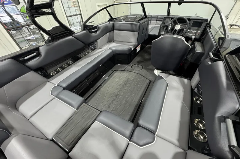 Slide: The Image of Interior of 2026 Moomba Max boat with spacious seating and modern dashboard. - 9
