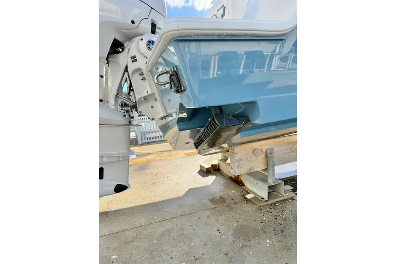 Slide: The Image of 2026 Contender 35 ST boat hull and engine detail on a stand. - 11