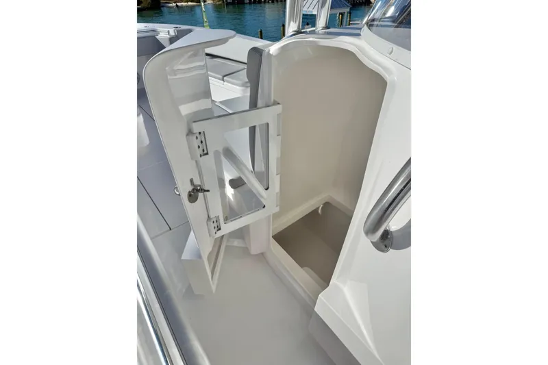 Slide: The Image of Open storage compartment on 2026 Contender 35 ST boat, featuring sleek white design. - 15