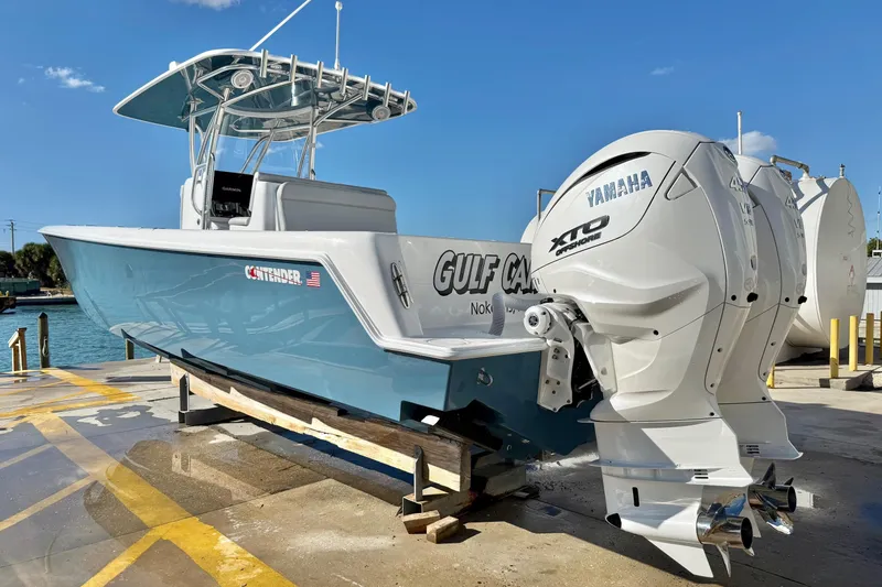 Slide: The Image of 2026 Contender 35 ST boat with Yamaha engines, docked on a sunny day. - 4