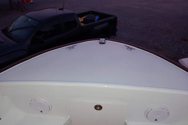 Slide: The Image of 1977 Wellcraft 270 Coastal O/B boat bow with speakers, parked near a black truck. - 12