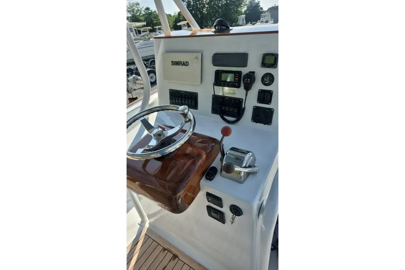 Slide: The Image of 1977 Wellcraft 270 Coastal O/B boat dashboard with steering wheel and controls. - 16