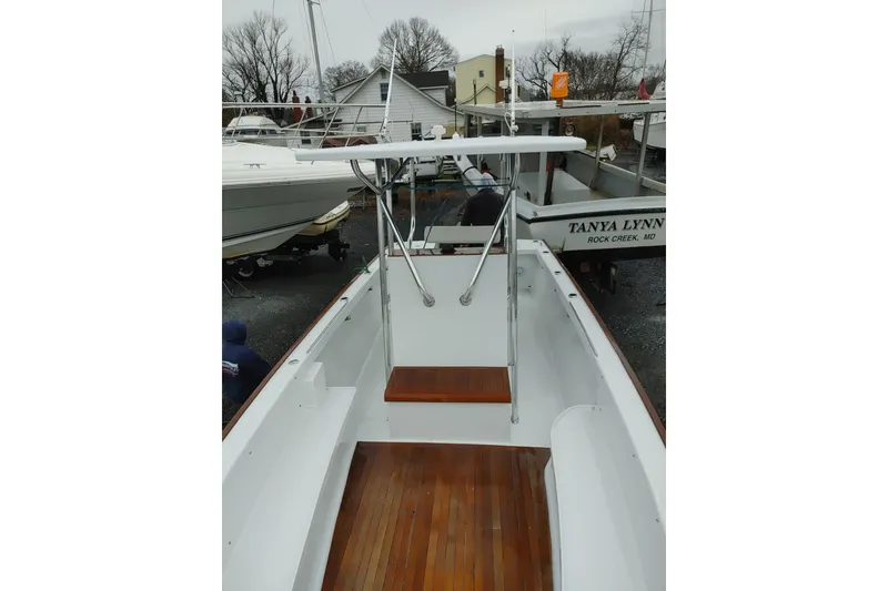 Slide: The Image of 1977 Wellcraft 270 Coastal O/B boat with wooden deck, docked in a marina. - 17
