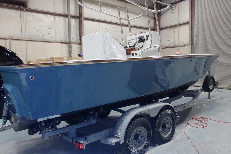 Slide: The Image of 1977 Wellcraft 270 Coastal O/B boat on trailer in warehouse setting. - 18