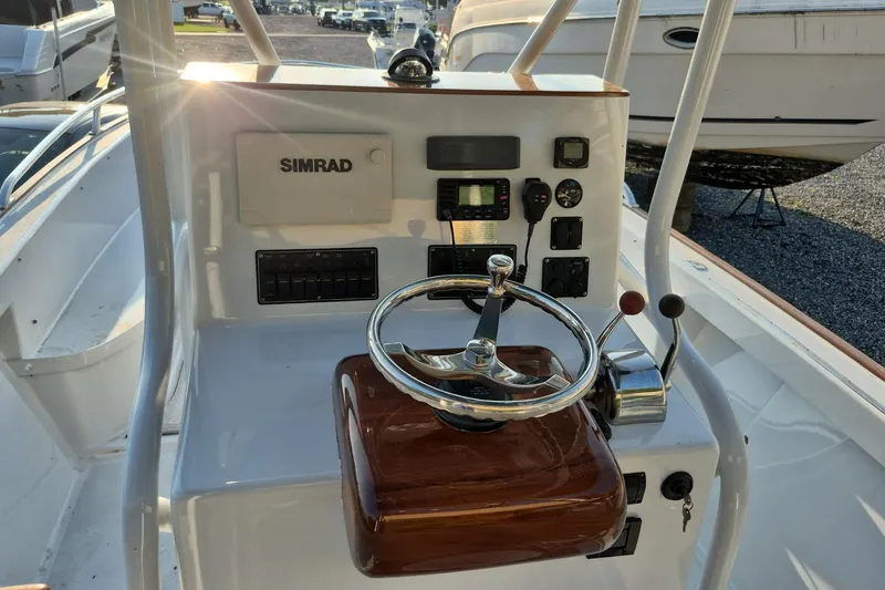 Slide: The Image of 1977 Wellcraft 270 Coastal O/B boat helm with Simrad electronics and steering wheel. - 2