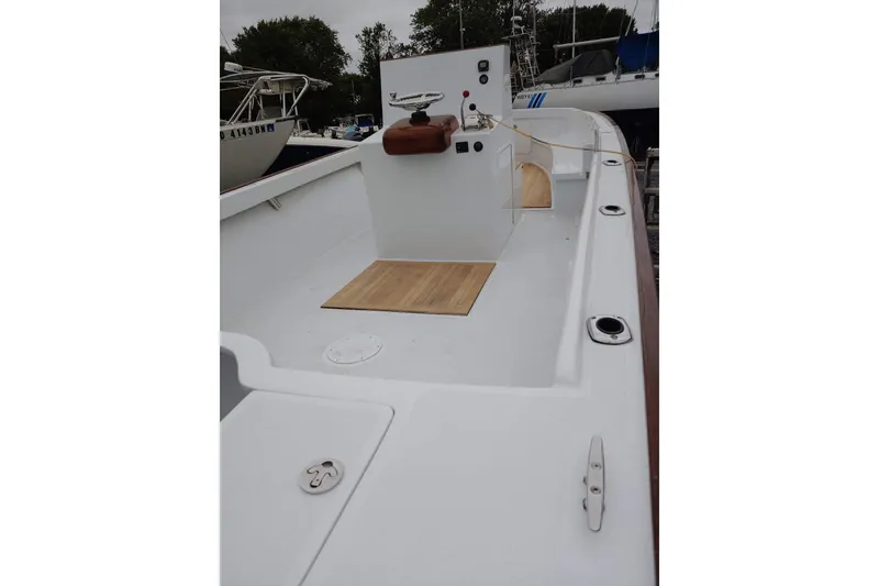 Slide: The Image of 1977 Wellcraft 270 Coastal O/B boat deck with wooden flooring and control panel. - 21