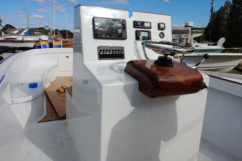 Slide: The Image of 1977 Wellcraft 270 Coastal O/B boat dashboard with steering wheel and control panel. - 23