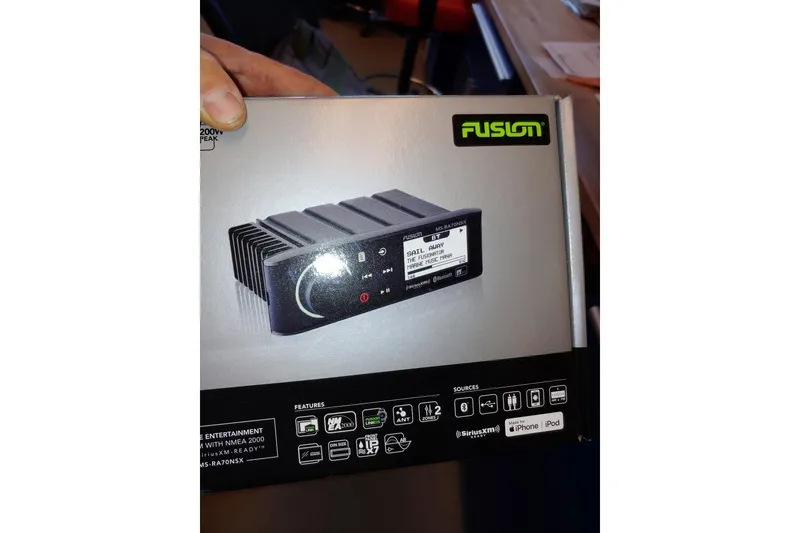 Slide: The Image of Box of Fusion marine stereo system, model MS-RA70NSX, featuring Bluetooth and NMEA 2000 compatibility. - 24