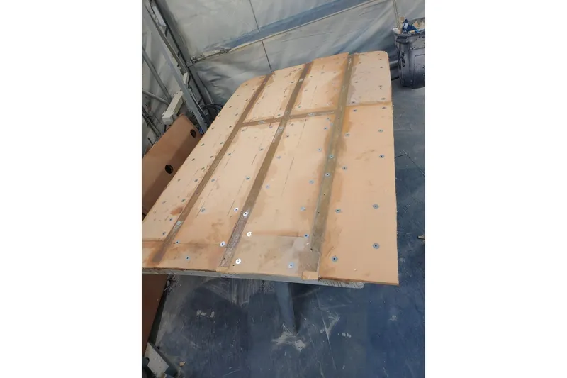 Slide: The Image of Wooden panel with metal fasteners, likely part of a 1977 Wellcraft 270 Coastal O/B boat. - 7