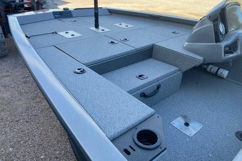 Slide: The Image of 2026 G3 Sportsman 1710 PFX boat interior with storage compartments and steering console. - 11