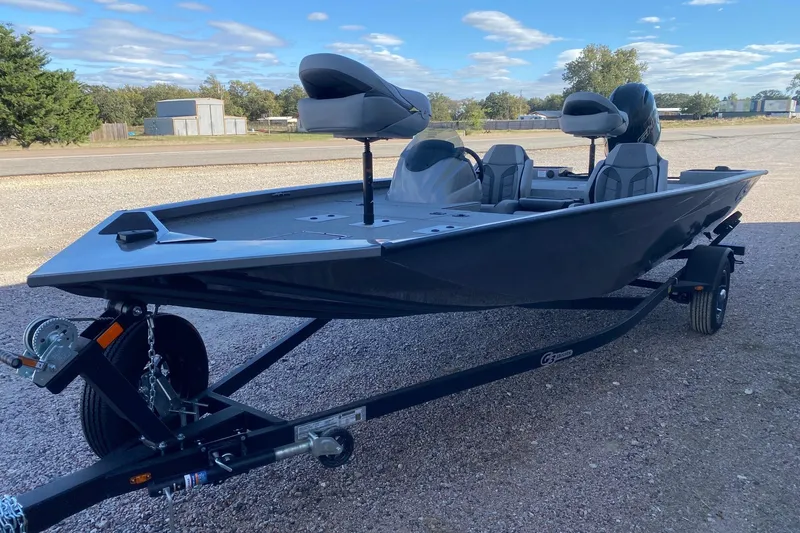 Slide: The Image of 2026 G3 Sportsman 1710 PFX boat on trailer, parked outdoors under blue sky. - 3