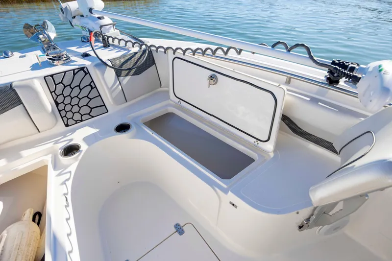 Slide: The Image of 2019 Wellcraft 222 Fisherman boat interior with storage compartment and fishing rod holders. - 11